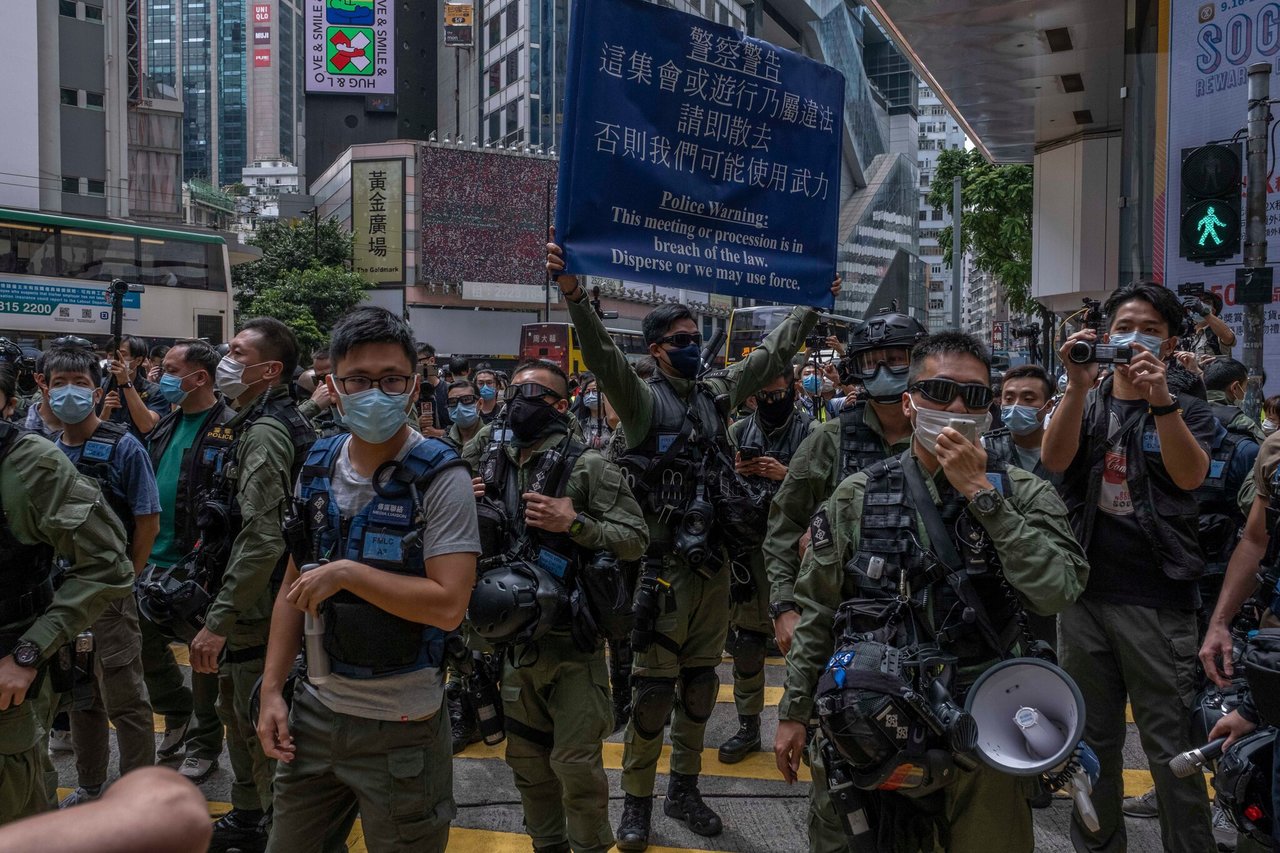 Hong Kong celebrates 'return of peace', detains dozens of people