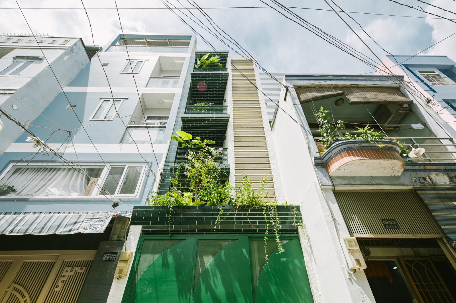 A Slim Green Home in Vietnam Rises Like a Tendril Out of Concrete
