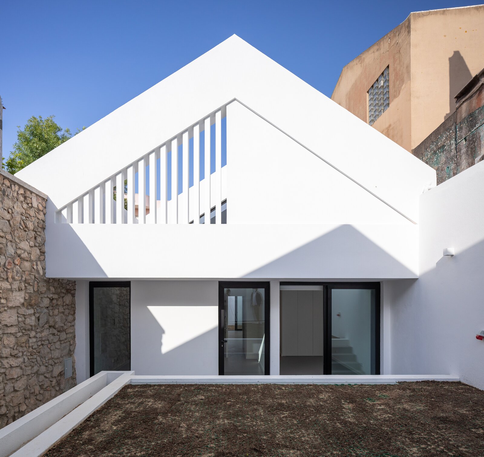 An 18th-Century Sawmill in Portugal Is Revived as a Striking White Gable Home