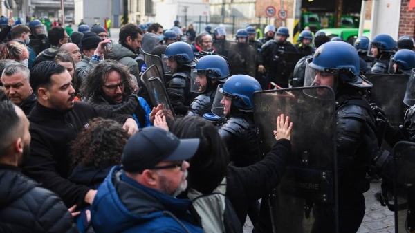 Hundreds detained in fiery protests after French government forces through pension reforms